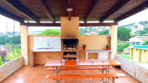 a kitchen with a table on a balcony at VILLA BLANCA 10 minutos de la Playa Costa brava in Maçanet de la Selva
