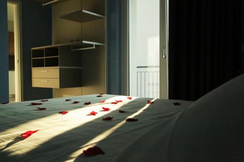 a bedroom with a bed with red roses on it at Il Cubo di Anja Home of amazing view in Pisogne