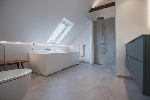 a bathroom with a toilet and a sink and a shower at Hotel Højgaarden in Slettestrand