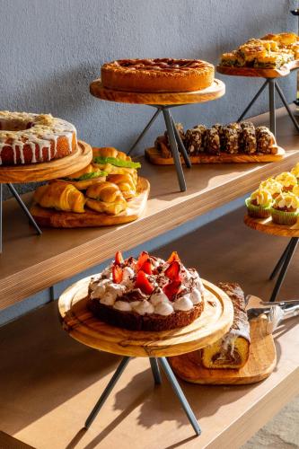 a display of different types of cakes and pastries at Skiathos Avaton Suites & Villas, Philian Hotels and Resorts in Megali Ammos