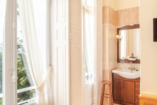 a bathroom with a sink and a window at Villa La Argentina in Luarca