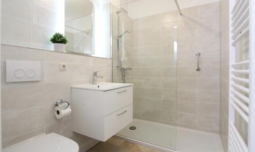 a bathroom with a toilet and a sink and a shower at Ferienwohnung Ines in Kühlungsborn