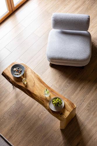 a coffee table with a bowl of grapes and a couch at Skiathos Avaton Suites & Villas, Philian Hotels and Resorts in Megali Ammos