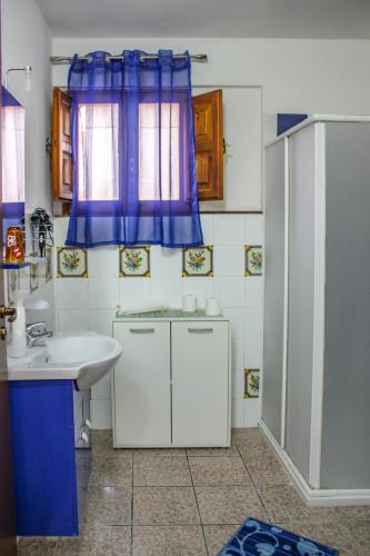 a bathroom with a sink and a shower at Apartment Timpirussimare in Sciacca