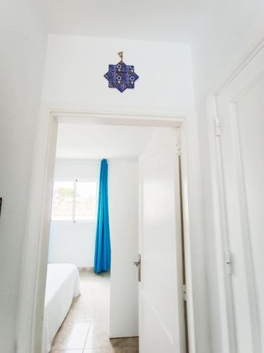 a white room with a door with a blue curtain at AVATEA in Corralejo