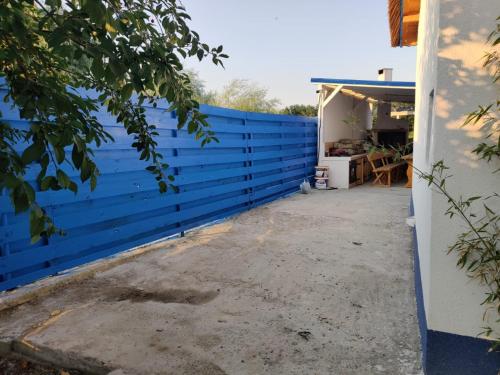 a blue fence next to a house at Wild Carp in Dunavăţu de Jos