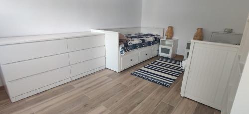 a bedroom with a bed and a dresser at Wild Carp in Dunavăţu de Jos