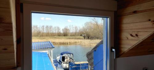 a view from a door of a boat on a lake at Wild Carp in Dunavăţu de Jos