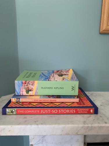 four books stacked on top of each other on a table at The Knowle at St Leonards in St. Leonards