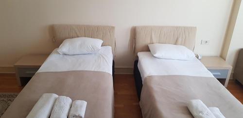 two beds in a small room at Baku Sea View Hotel in Baku