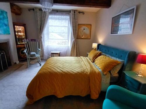 a bedroom with a bed and a couch at Hebden Bridge - House - Sleeps 8 - Pet Friendly in Hebden Bridge