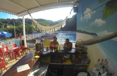 two people sitting at a bar on a cruise ship at Camping Igara de San Sebastian in Donostia-San Sebastián