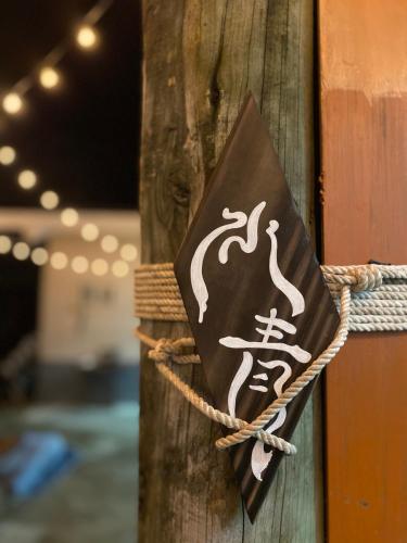 a sign on a wooden pole with a pirate sign on it at 水青潛水旅宿 Water Blue in Green Island