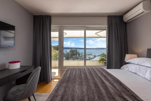 a bedroom with a bed and a view of the ocean at Apartments Sax in Crikvenica