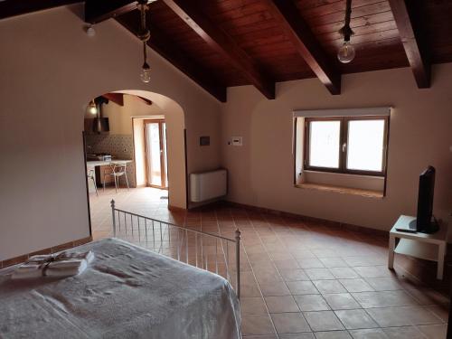 a large room with a bed and a living room at Masseria Le Zavattole in Sasso