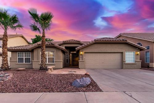 a house with palm trees in front of it at Baylor Gilbert home in Gilbert