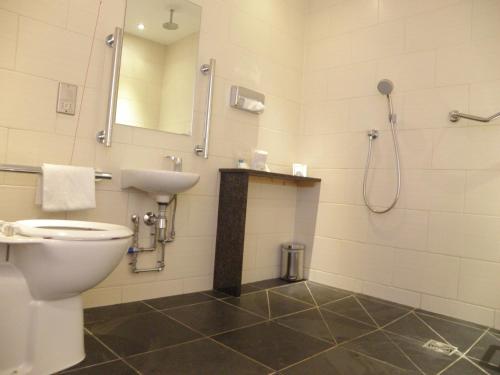 a bathroom with a toilet and a sink and a shower at Holiday Inn Darlington-A1 Scotch Corner by IHG in Scotch Corner