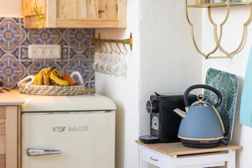 a kitchen with a refrigerator and a tea kettle on a table at פינה שקטה בראש פינה העתיקה Quite Corner in old Rosh-Pina in Rosh Pinna