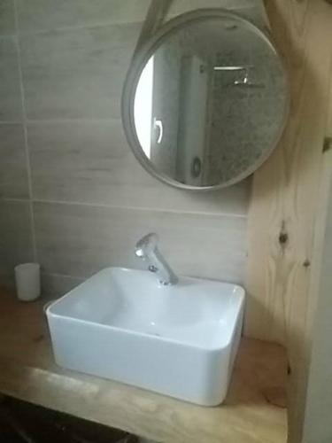 a bathroom with a sink and a mirror on the wall at Studio dans les pins Lacanau in Lacanau