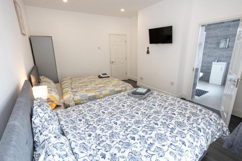 a bedroom with a bed and a tv in it at TCO Luxury House in Liverpool
