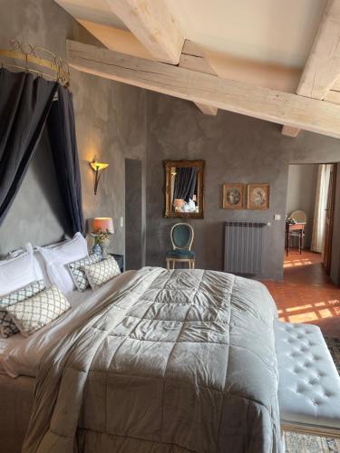 a bedroom with a large bed in a room at La Maison de Platane B&B in Fayence