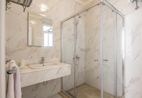 a bathroom with a sink and a shower at Prime Holidays Seashell in El Alamein