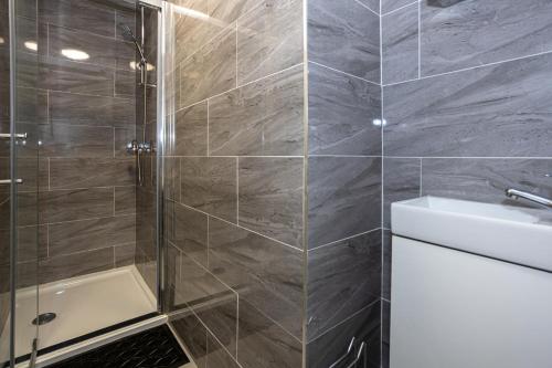 a bathroom with a shower and a sink and a toilet at TCO Luxury House in Liverpool