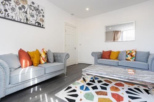 a living room with two couches and a coffee table at TCO Luxury House in Liverpool