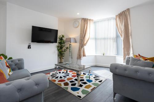 a living room with two couches and a table at TCO Luxury House in Liverpool