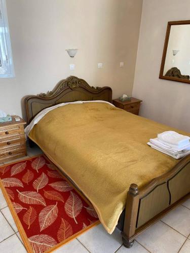 a bedroom with a large bed and a mirror at Fabrica apartments in Apeiranthos