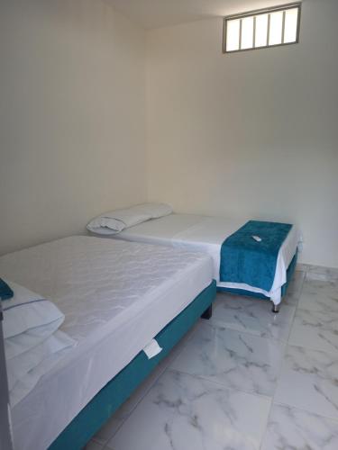 two beds sitting next to each other in a room at Proyecto MOONLIGHT in Villavieja