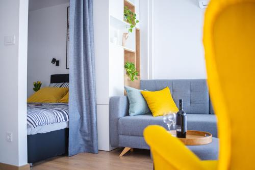 a living room with a couch and a bed at Dada's Cosy Condo in Zagreb