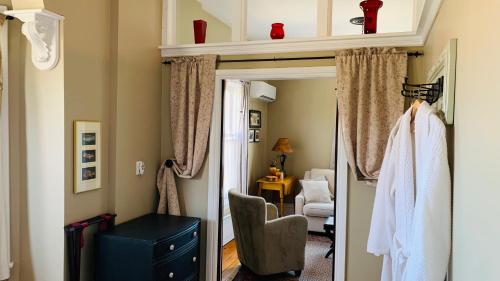 a room with a mirror and a chair in a room at The 1885 Suites in Picton