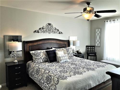 um quarto com uma cama e uma ventoinha de tecto em Peaceful 1st floor lakeside condo minutes from Osage Beach and Ozark State Park em Kaiser