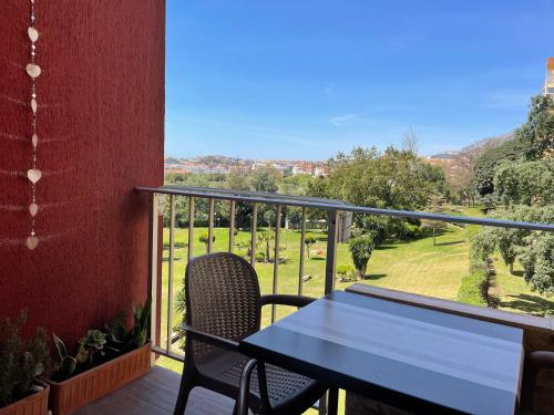 a table and chair on a balcony with a view at Aparthotel Minerva in Benalmádena