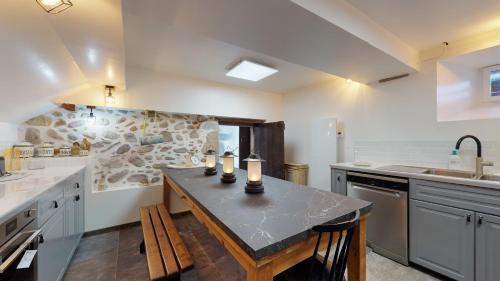 a large kitchen with a table with candles on it at Château Porthos Tranquillité des Pyrénées in Lanne en Barétous