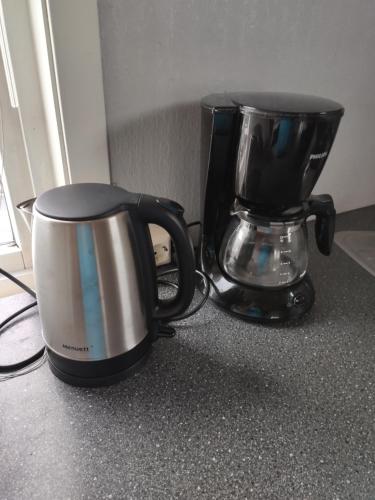 a coffee maker and a toaster on a counter at FeelHome One bedroom apartment Vidarsveg in Tromsø