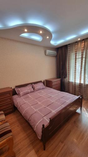 a bedroom with a large bed in a room at Cosy appartment in Tashkent