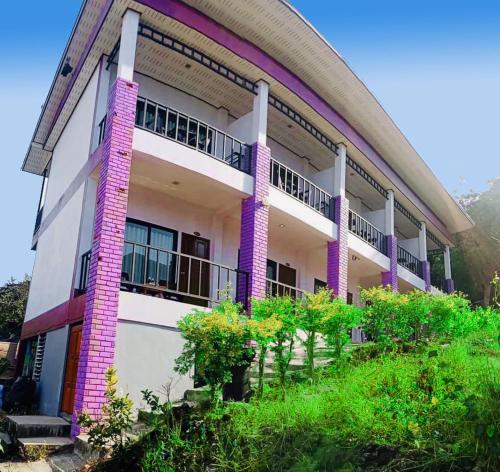 a building with purple columns and balconies at View Garden Resort in Phi Phi Islands