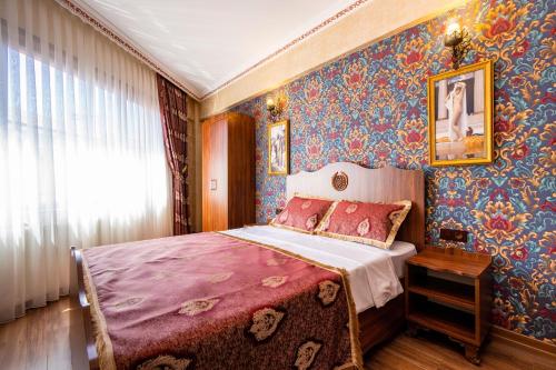 a bedroom with a bed in a room with wallpaper at The First Ottoman Dream in Istanbul