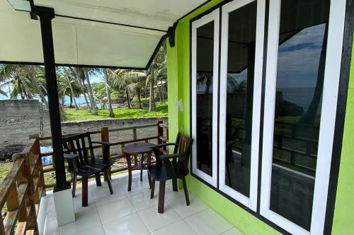 a patio with tables and chairs on a building at RedDoorz Syariah near Ujong Kareung Beach Sabang in Kota Bawah Timur