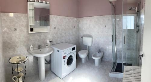 a bathroom with a washing machine and a washer at il Podere La Casina in Monsummano Terme