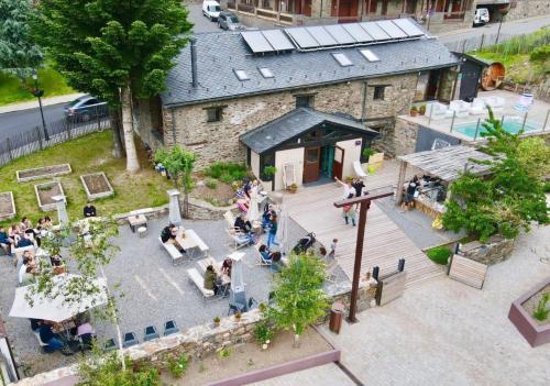 an overhead view of a building with people sitting at tables at Mountain Hostel Tarter in El Tarter