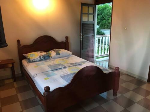 מיטה או מיטות בחדר ב-Villa Mer'Pelée