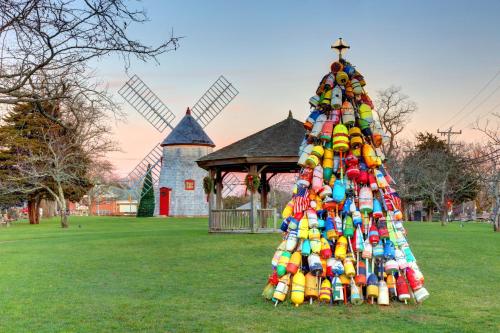 a christmas tree in front of a windmill at Inn at the Oaks in Eastham