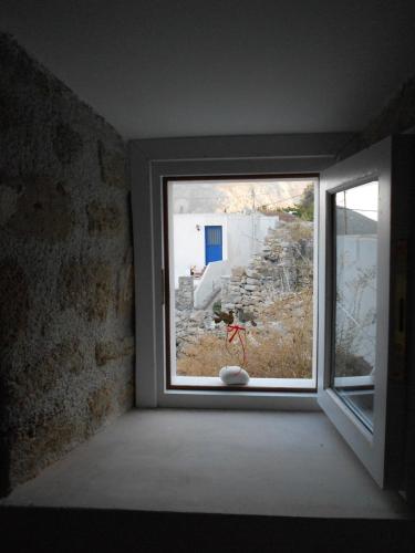 a window in a room with a view of a building at villa Elpiniki Tilos in Megálon Choríon