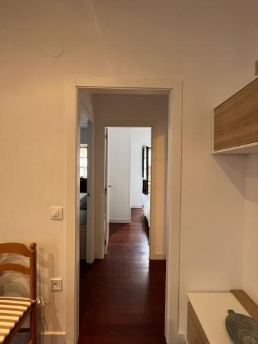 a hallway leading to a room with a bedroom at Apartamento en el centro de Llanes in Llanes