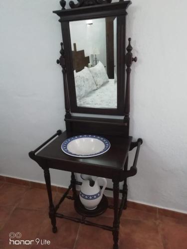 a table with a mirror on top of it at Casa Cueva El Almendro in Pegalajar