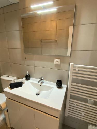 a bathroom with a sink and a mirror at Vernon, Le Donalice in Vernon