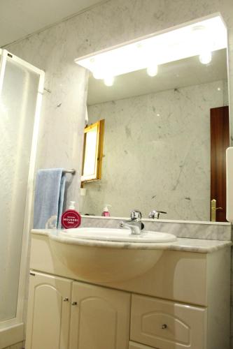 a bathroom with a sink and a mirror at marsupilami in Pobla de Segur